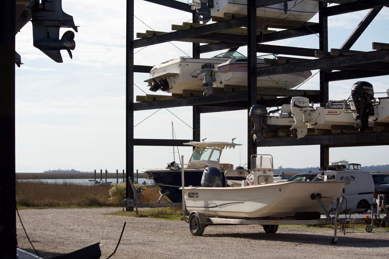 Boats stored on racks in a marina storage yard