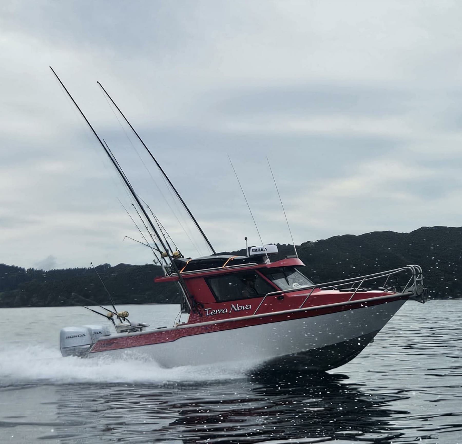 Alloy hardtop fishing boat under way off the New Zealand coast